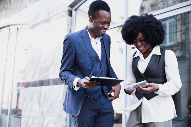 smiling-african-young-businessman-businesswoman-holding-clipboard-digital-tablet_23-2148190680